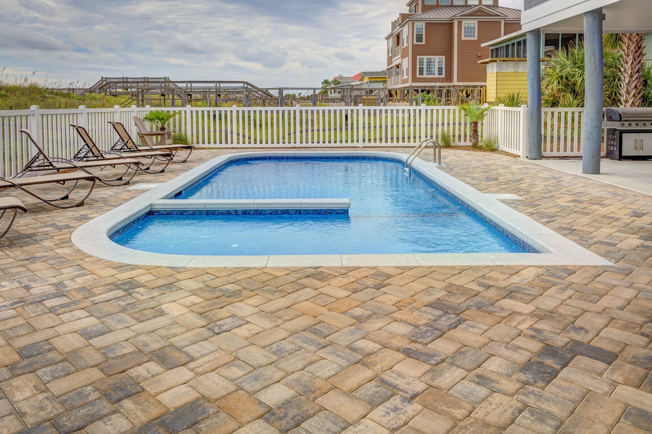 Backyard pool with stone patio