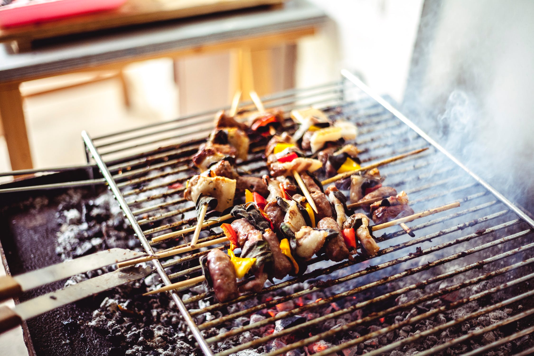 Kabob skewers with meat and veggies on hot backyard grill