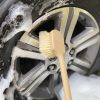 Long Handled Scrub Brush scrubbing wheels on a car