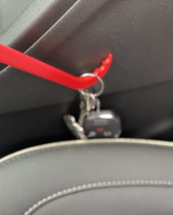Handy-Hook Brush being used to pull keys our from side of car seat and middle console