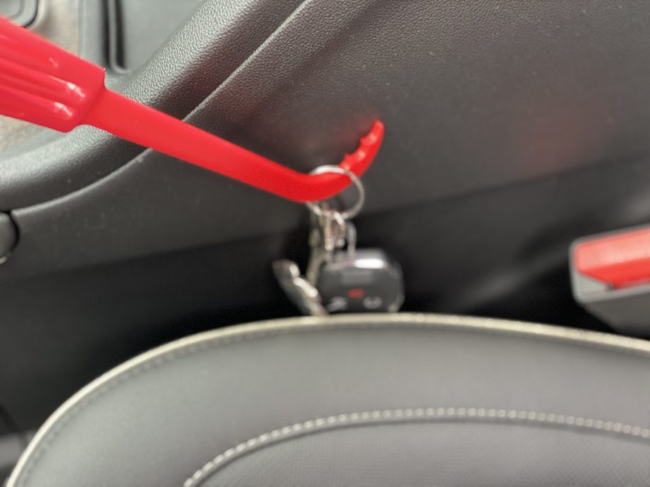 Handy-Hook Brush being used to pull keys our from side of car seat and middle console